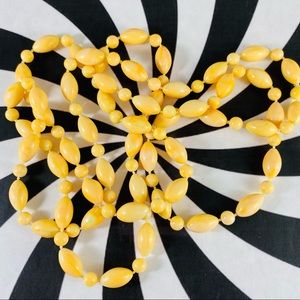 Wonderful vintage super long pale yellow plastic beaded necklace